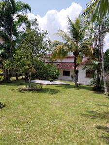 a house with palm trees in the yard at Cop 30 urban Amazon Paradise 5 bedrooms 7 beds in Ananindeua