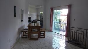 a kitchen with a table and a door to a balcony at Cop 30 urban Amazon Paradise 5 bedrooms 7 beds in Ananindeua