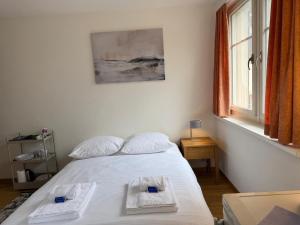 a bedroom with a bed with two towels on it at Charming Riverside Studio - Stork 41 in Zurich