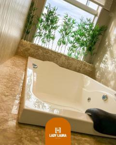 a white bath tub in a bathroom with a window at Lady Laura Hotel  +49 photos