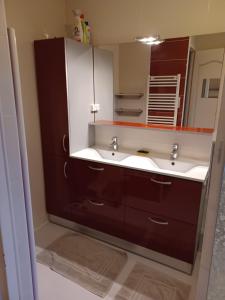 a bathroom with a sink and a mirror at Maison cozy dans les Volcans in Sayat +30 photos