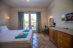 a bedroom with a bed and a desk with a mirror at Kaya Amari in Fethiye