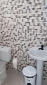 a bathroom with a toilet and a sink at Pousada Bela Vista in Castro +18 photos