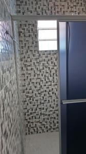 a shower with a glass door in a bathroom at Pousada Bela Vista in Castro