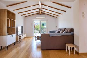 a living room with a couch and a tv at Cozy Sofita In Chios Island in Chios