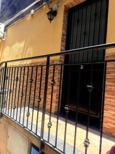 a balcony with a black railing next to a door at Garibaldi Rooms 2 in Catania