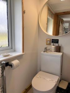 a bathroom with a toilet and a mirror at AURORA rural RETREATs in Glendale +109 photos