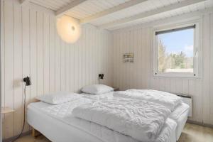 a white bed in a room with a window at LN1911-Hjorring-Under-Bjergene-3 in Hjørring