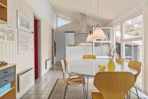 a kitchen and dining room with a table and chairs at LN1911-Hjorring-Under-Bjergene-3 in Hjørring