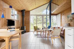 a kitchen and living room with a table and chairs at LN1965-Hirtshals-Klinken-11 in Hirtshals