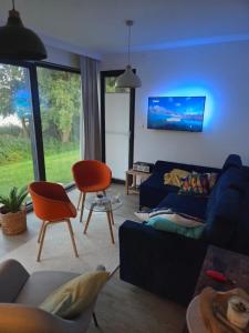 a living room with a couch and chairs at Skryjówka in Chrzypsko Wielkie