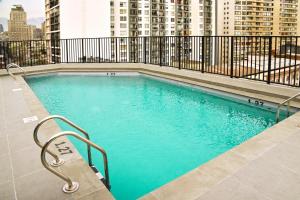 a swimming pool on the roof of a building at Apart Hotel HW Compañia in Santiago