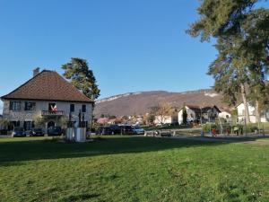 a building in a park with a green field at Le Renardeau in Brison-Saint-Innocent +16 photos