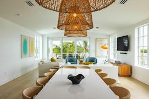 a living room with a large table and chairs at The Joyrise House at Solaire Lunara Bay in Key West