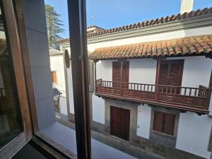 a window view of a building with a balcony at Casa Pino Teror in Teror +11 photos