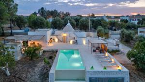 an aerial view of a house with a swimming pool at Rock'n'Trullo 4 bedroom privatepool by TripOstuni in Ostuni