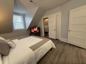 a bedroom with a bed and a fireplace in it at Peaceful 1 BR Home with parking near hospital in Wilmington