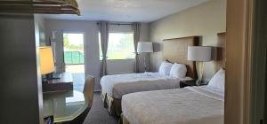 a hotel room with two beds and a window at Sunrise Inn in Eastman