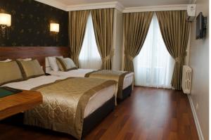 a hotel room with two beds and a window at Dekor Hotel in Istanbul