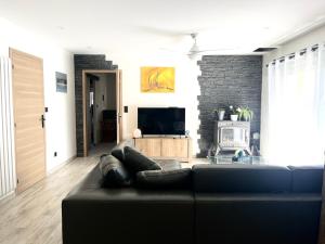 a living room with a couch and a tv at Sub zéro in Saint-Jean-de-Tholome