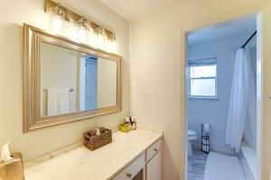a bathroom with a sink and a mirror at Near Shops and Eats Commuter-Friendly FWTX Home in Fort Worth +21 photos
