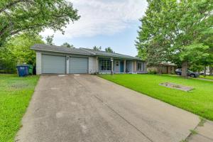a house with a driveway in front of it at Near Shops and Eats Commuter-Friendly FWTX Home in Fort Worth