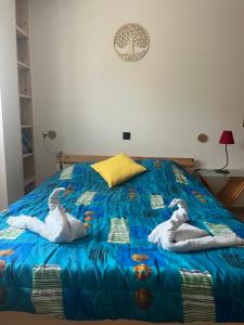 two stuffed swans are laying on a bed at Sub zéro in Saint-Jean-de-Tholome