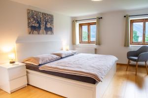 ein Schlafzimmer mit einem großen weißen Bett in einem Zimmer in der Unterkunft Ferienhaus Christian in Traunkirchen