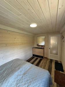a bedroom with a bed and a wooden ceiling at Панорама Пікуй in Belasovitsa +5 photos
