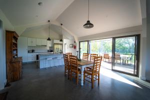 a kitchen and dining room with a table and chairs at Ravenscroft Cottage in Eccleston