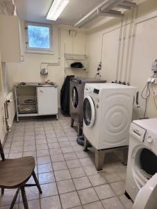 a laundry room with a washing machine and a washer at Nordic Calm Forest Apartment in Hävla