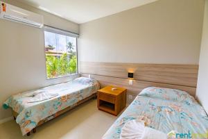 a bedroom with two beds and a window at Ykutiba Imbassaí - Apartamento Superior - I104 in Imbassai +31 photos