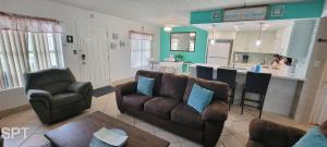 a living room with a couch and a kitchen at Fiesta Sol #110 home in South Padre Island