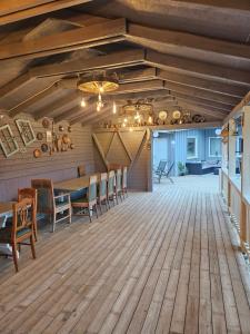 a dining room with a table and chairs on a wooden floor at Cabana Vikingilor Bucovina in Vama