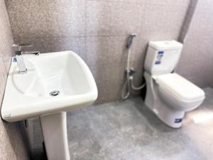 a bathroom with a sink and a toilet at Happy Haven Homestay in Anuradhapura