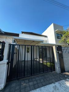 a house with a gate and a building at Villa Nayana In The heart of Semiya in Seminyak
