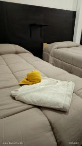 a yellow towel sitting on top of two beds at Hotel LE MIRAGE in Mar del Plata +15 photos
