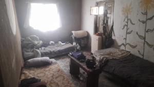 a living room with two beds and a window at Tribu 13 Eco Village in Las Escobas
