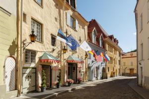 eine leere Straße in einer Stadt mit Flaggen auf Gebäuden in der Unterkunft Schlössle Hotel - The Leading Hotels of the World in Tallinn