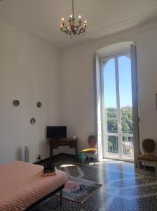 a bedroom with a bed and a window with a view at Hostello Genovese in Genova