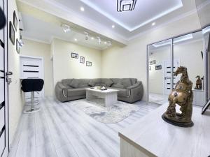 un soggiorno con un divano e un tavolo di Modern 2BR Luxury -10 Min Walk to Old Town a Bukhara