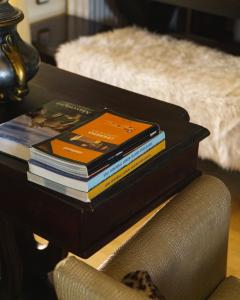 a stack of books sitting on top of a table at Villa Tethys Mountain Resort in Zákas