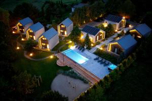 an aerial view of a house with a swimming pool at night at SKARPA resort in Ustronie Morskie