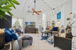 a living room with couches and a ceiling fan at Opal 233 in Palm-Eagle Beach