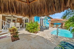 a villa with a swimming pool and a resort at Opal 233 in Palm-Eagle Beach