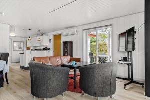 a living room with a couch and a table at SJ227-Hejls-Ae-Skovbryn-33 in Hejls