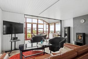 a living room with a couch and a flat screen tv at SJ227-Hejls-Ae-Skovbryn-33 in Hejls