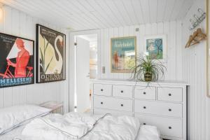 a bedroom with a bed and a dresser and posters at SJ204-Borkop-Pytvej-1 in Børkop