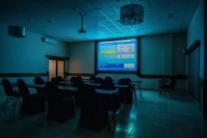a room with tables and chairs and a projection screen at Kang Juliet Hotel in Kang +30 photos