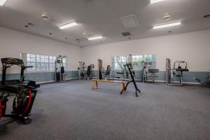 a gym with treadmills and machines in a room at Relaxing Beach Villa Walk to Ocean Plus 3 Pools, Tennis & Trails in Edgewater
